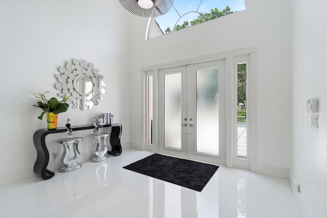 8076 Twin Lake Dr, Boca Raton, FL 33496 - tiled entryway with a towering ceiling, french doors, and baseboards