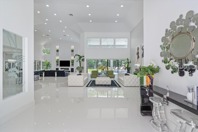 8076 Twin Lake Dr, Boca Raton, FL 33496 - tiled living area featuring a towering ceiling and recessed lighting