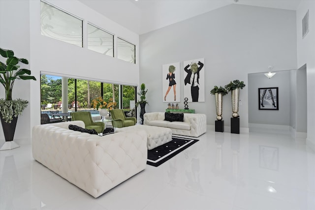 8076 Twin Lake Dr, Boca Raton, FL 33496 - living area featuring high vaulted ceiling, tile patterned flooring, and baseboards