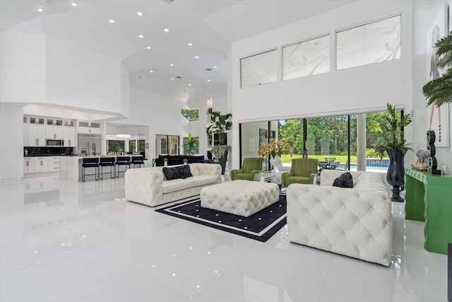 8076 Twin Lake Dr, Boca Raton, FL 33496 - living room featuring high vaulted ceiling, light tile patterned floors, and recessed lighting