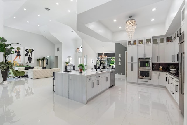 8076 Twin Lake Dr, Boca Raton, FL 33496 - kitchen featuring a chandelier, stainless steel appliances, recessed lighting, open floor plan, and white cabinetry