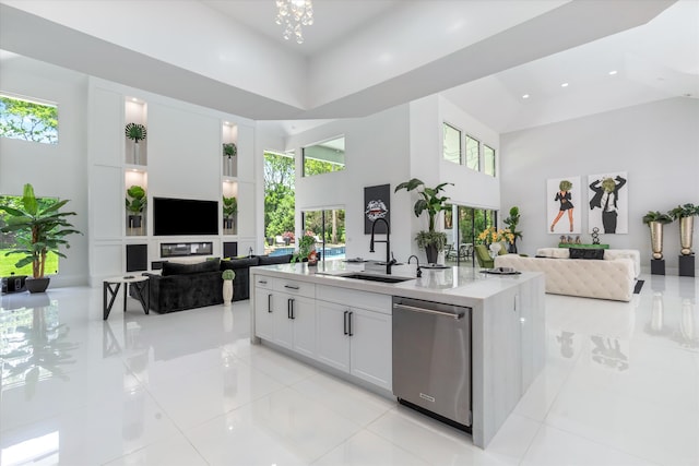8076 Twin Lake Dr, Boca Raton, FL 33496 - kitchen with open floor plan, stainless steel dishwasher, a towering ceiling, a sink, and light countertops