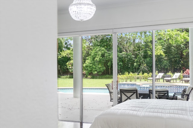 8076 Twin Lake Dr, Boca Raton, FL 33496 - bedroom featuring crown molding, a chandelier, multiple windows, and view of wooded area