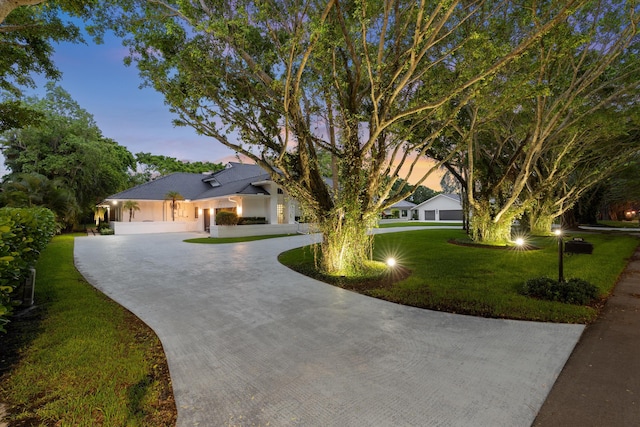 8076 Twin Lake Dr, Boca Raton, FL 33496 - view of front of property featuring curved driveway, a front yard, and stucco siding