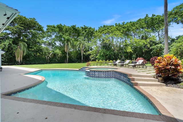 8076 Twin Lake Dr, Boca Raton, FL 33496 - view of swimming pool featuring view of wooded area, a patio, and a pool with connected hot tub