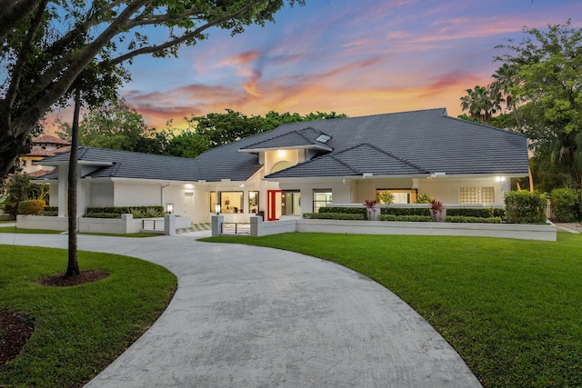 8076 Twin Lake Dr, Boca Raton, FL 33496 - view of front of house featuring curved driveway, stucco siding, and a tiled roof