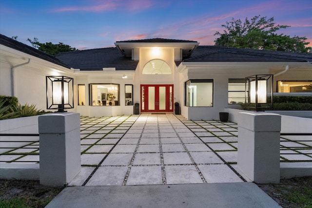 8076 Twin Lake Dr, Boca Raton, FL 33496 - property entrance featuring stucco siding, french doors, and a tile roof