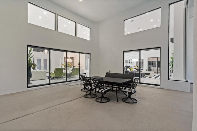 8076 Twin Lake Dr, Boca Raton, FL 33496 - dining room with a towering ceiling, concrete floors, and plenty of natural light