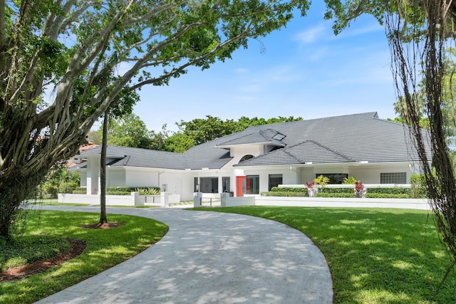 8076 Twin Lake Dr, Boca Raton, FL 33496 - view of front of house featuring a front lawn, a tiled roof, and stucco siding