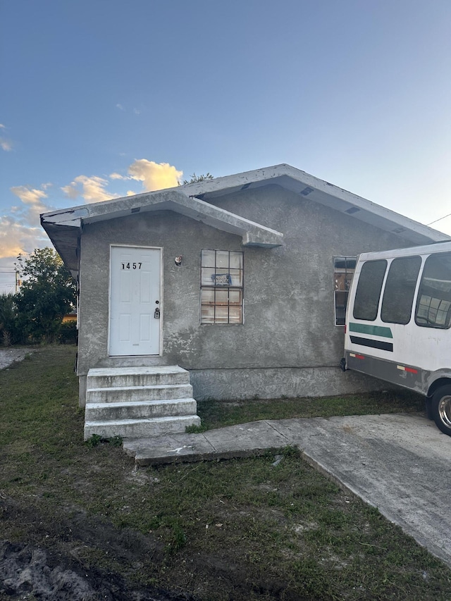 1457 W 32nd St, Riviera Beach, FL 33404 - view of front of property with entry steps and stucco siding