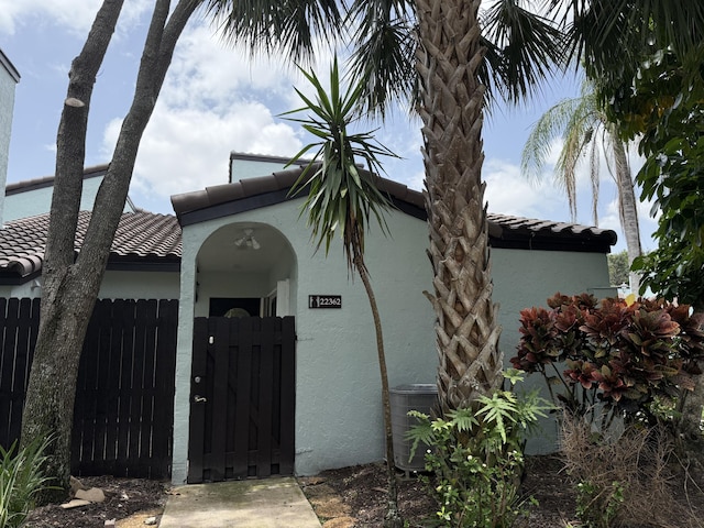 22362 Pineapple Walk Dr, Boca Raton, FL 33433 - view of home's exterior with stucco siding, a gate, and a tile roof