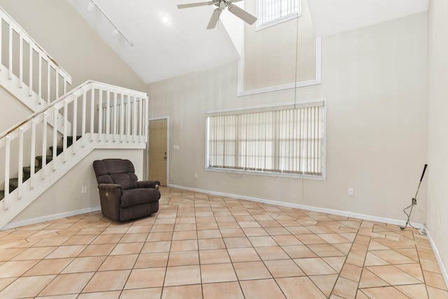 14685 40th St N, Loxahatchee Groves, FL 33470 - unfurnished room with high vaulted ceiling, a ceiling fan, stairs, baseboards, and tile patterned flooring