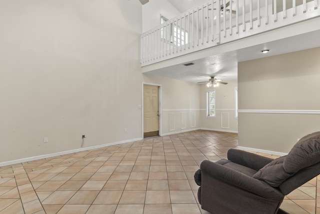 14685 40th St N, Loxahatchee Groves, FL 33470 - living area featuring a ceiling fan, a high ceiling, and light tile patterned floors