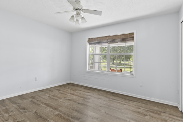 14685 40th St N, Loxahatchee Groves, FL 33470 - unfurnished room with wood finished floors, baseboards, and a ceiling fan