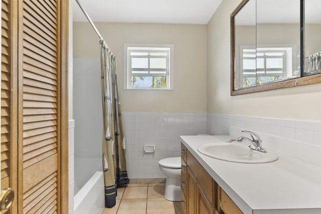 14685 40th St N, Loxahatchee Groves, FL 33470 - full bath featuring tile walls, vanity, tile patterned floors, toilet, and a wainscoted wall