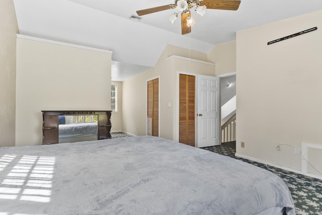 14685 40th St N, Loxahatchee Groves, FL 33470 - bedroom featuring attic access, lofted ceiling, carpet floors, two closets, and a ceiling fan