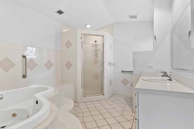 14685 40th St N, Loxahatchee Groves, FL 33470 - full bathroom featuring a shower stall, a tub with jets, tile walls, vanity, and tile patterned flooring