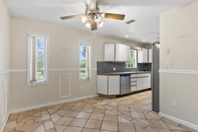 14685 40th St N, Loxahatchee Groves, FL 33470 - kitchen with a ceiling fan, dishwasher, white cabinetry, and healthy amount of natural light