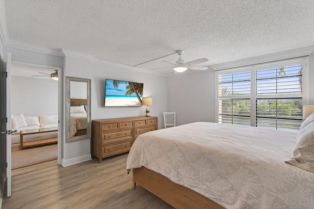 22 Royal Palm Way Unit 205, Boca Raton, FL 33432 - bedroom with a textured ceiling, light wood finished floors, ornamental molding, and ceiling fan