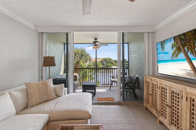 22 Royal Palm Way Unit 205, Boca Raton, FL 33432 - living room featuring a ceiling fan, crown molding, a textured ceiling, expansive windows, and carpet floors
