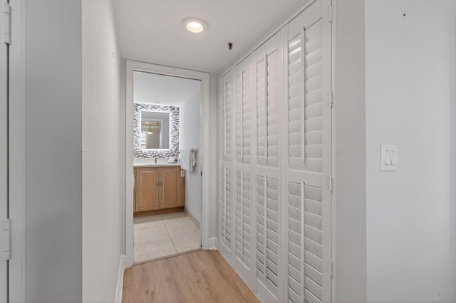 22 Royal Palm Way Unit 205, Boca Raton, FL 33432 - hallway with light wood finished floors and baseboards