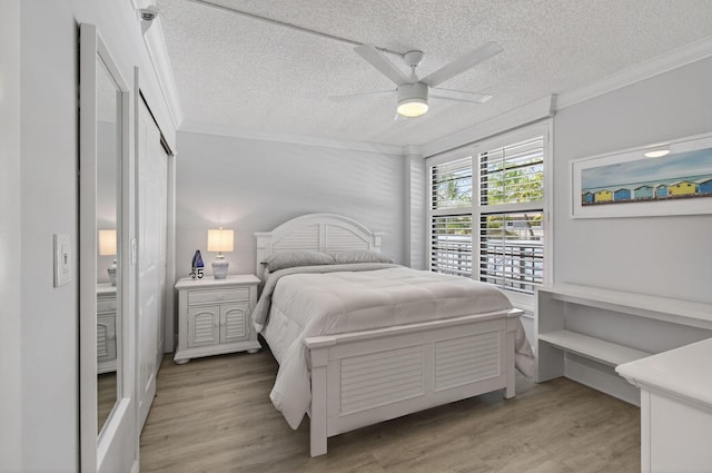 22 Royal Palm Way Unit 205, Boca Raton, FL 33432 - bedroom featuring ornamental molding, a textured ceiling, light wood-style flooring, and ceiling fan