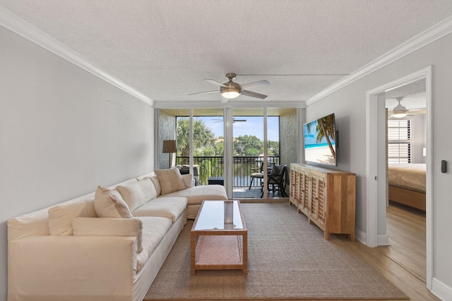22 Royal Palm Way Unit 205, Boca Raton, FL 33432 - living room with a ceiling fan, plenty of natural light, crown molding, a textured ceiling, and light wood finished floors