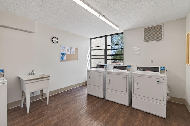 22 Royal Palm Way Unit 205, Boca Raton, FL 33432 - shared laundry room featuring washing machine and clothes dryer, dark wood-type flooring, and a textured ceiling