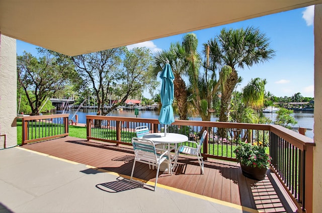 22 Royal Palm Way Unit 205, Boca Raton, FL 33432 - wooden terrace with a water view, outdoor dining space, and a lawn