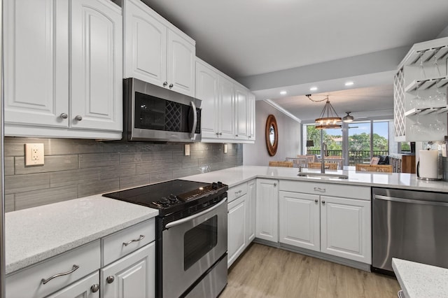 22 Royal Palm Way Unit 205, Boca Raton, FL 33432 - kitchen featuring stainless steel appliances, light wood-type flooring, white cabinetry, backsplash, and light stone counters