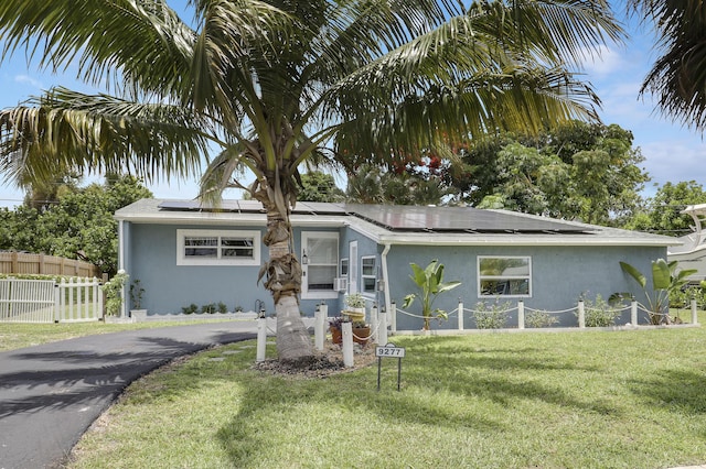9277 Bloomfield Dr, Palm Beach Gardens, FL 33410 - view of front of property featuring stucco siding and roof mounted solar panels