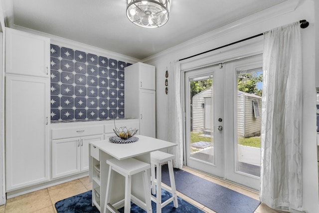 9277 Bloomfield Dr, Palm Beach Gardens, FL 33410 - dining area featuring french doors, crown molding, light tile patterned flooring, and wallpapered walls