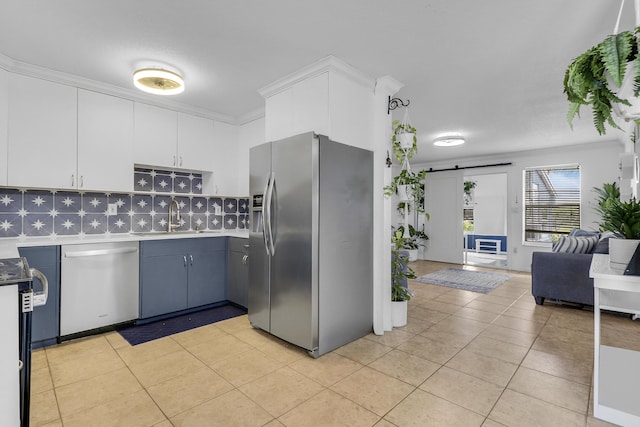 9277 Bloomfield Dr, Palm Beach Gardens, FL 33410 - kitchen featuring stainless steel appliances, a barn door, light tile patterned floors, decorative backsplash, and white cabinets