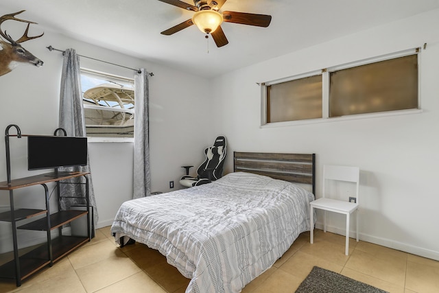 9277 Bloomfield Dr, Palm Beach Gardens, FL 33410 - tiled bedroom with baseboards and ceiling fan