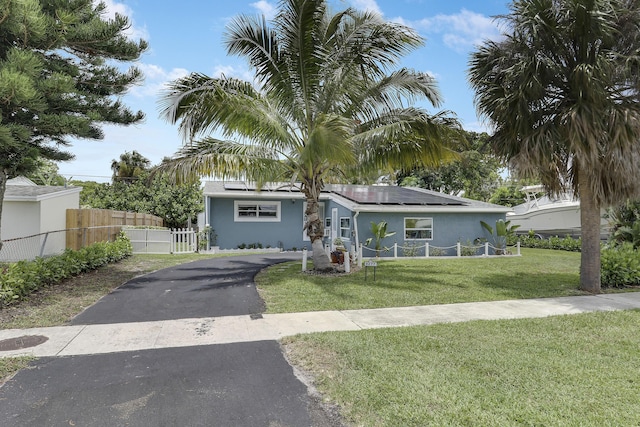 9277 Bloomfield Dr, Palm Beach Gardens, FL 33410 - view of front of home featuring solar panels, stucco siding, and asphalt driveway