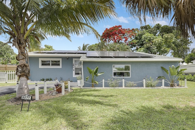 9277 Bloomfield Dr, Palm Beach Gardens, FL 33410 - single story home with stucco siding and roof mounted solar panels