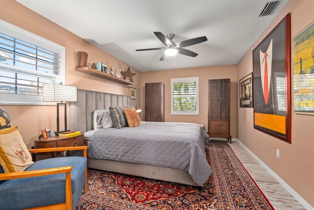 5551 SE Nassau Ter, Stuart, FL 34997 - bedroom featuring wood finished floors, baseboards, and ceiling fan