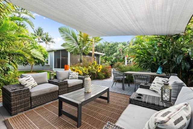 5551 SE Nassau Ter, Stuart, FL 34997 - view of patio / terrace with outdoor lounge area and a sunroom
