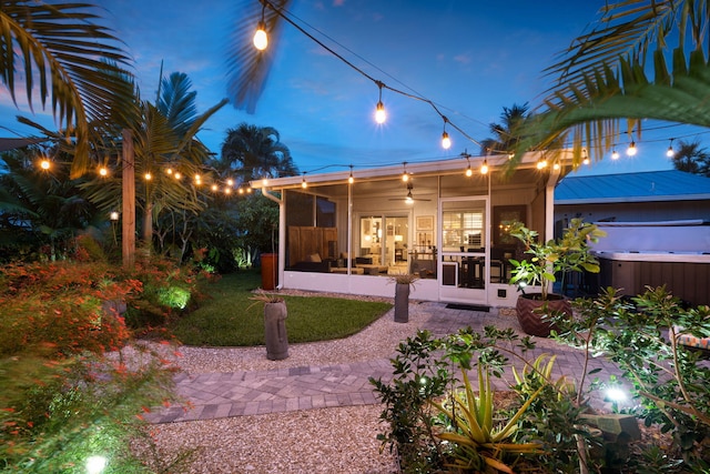 5551 SE Nassau Ter, Stuart, FL 34997 - rear view of house with a sunroom and a hot tub