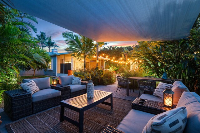 5551 SE Nassau Ter, Stuart, FL 34997 - patio terrace at dusk with an outdoor living space and a patio area