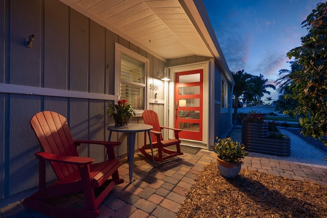 5551 SE Nassau Ter, Stuart, FL 34997 - exterior entry at dusk featuring board and batten siding