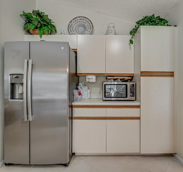 1500 Chapparel Way, Wellington, FL 33414 - kitchen featuring stainless steel appliances, light countertops, light tile patterned floors, a textured ceiling, and white cabinets
