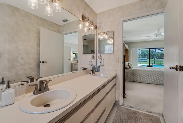 1500 Chapparel Way, Wellington, FL 33414 - ensuite bathroom with double vanity, tile patterned flooring, ceiling fan, and a chandelier