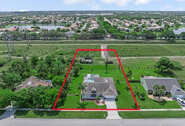 1500 Chapparel Way, Wellington, FL 33414 - aerial view of residential area with a large body of water and property boundaries highlighted
