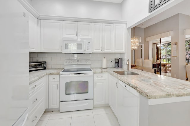 5414 Venetia Ct Unit G, Boynton Beach, FL 33437 - kitchen featuring white appliances, a sink, a peninsula, light tile patterned flooring, and tasteful backsplash