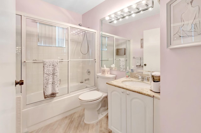 5414 Venetia Ct Unit G, Boynton Beach, FL 33437 - bathroom featuring vanity, toilet, enclosed tub / shower combo, and wood finished floors