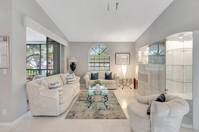5414 Venetia Ct Unit G, Boynton Beach, FL 33437 - living area with lofted ceiling, baseboards, and tile patterned floors