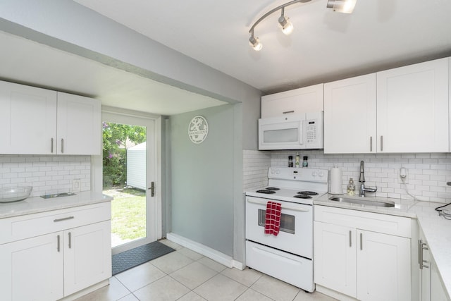 4337 Clinton Blvd, Lake Worth, FL 33461 - kitchen featuring white appliances, decorative backsplash, white cabinetry, and light tile patterned floors