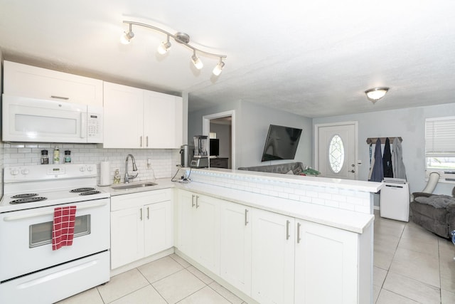 4337 Clinton Blvd, Lake Worth, FL 33461 - kitchen with white appliances, open floor plan, a peninsula, and light tile patterned flooring