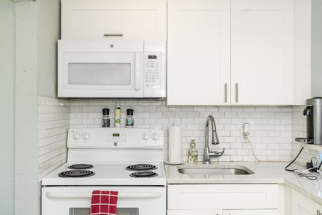 4337 Clinton Blvd, Lake Worth, FL 33461 - kitchen featuring white appliances, tasteful backsplash, white cabinetry, and light stone counters